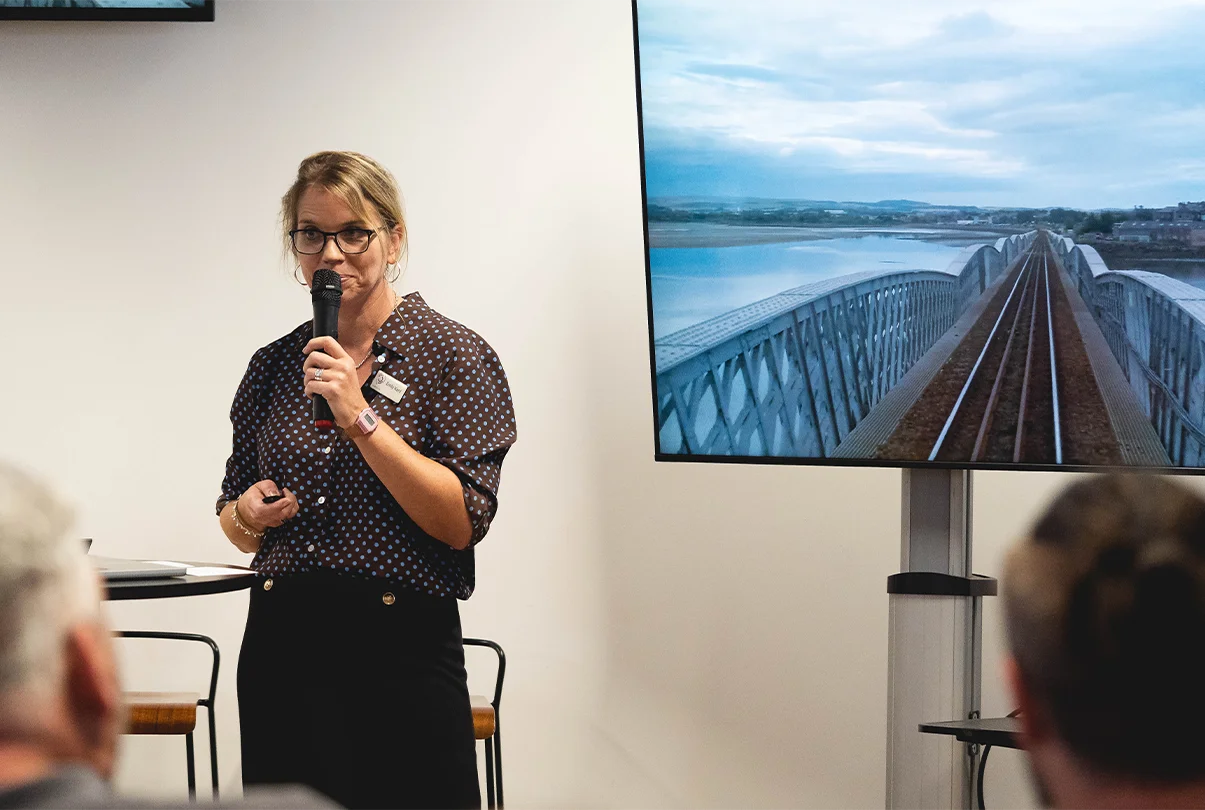 Emily Kent speaking into a microphone