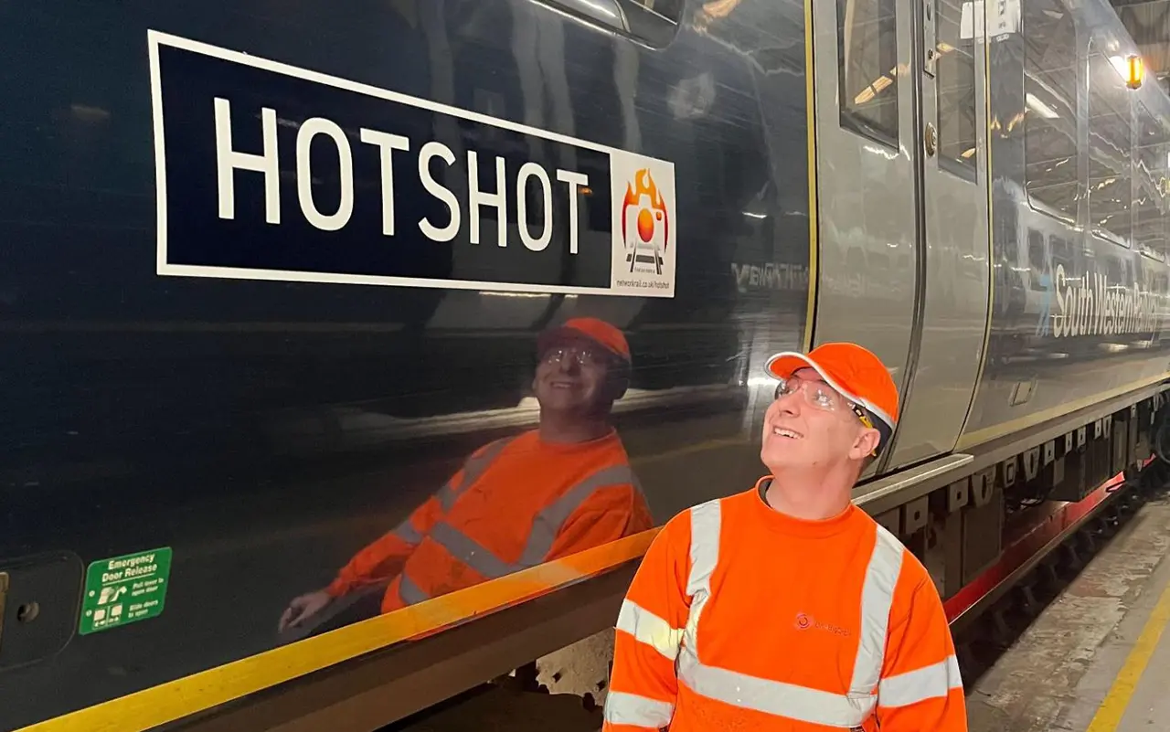 Worker beside train labelled HOTSHOT