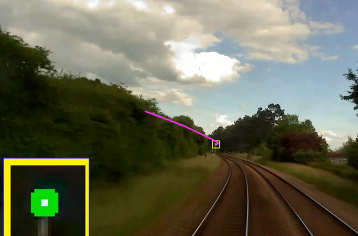 Forward-facing video showing a signal detected in the distance with a pink measurement line and signal inset showing a green aspect.