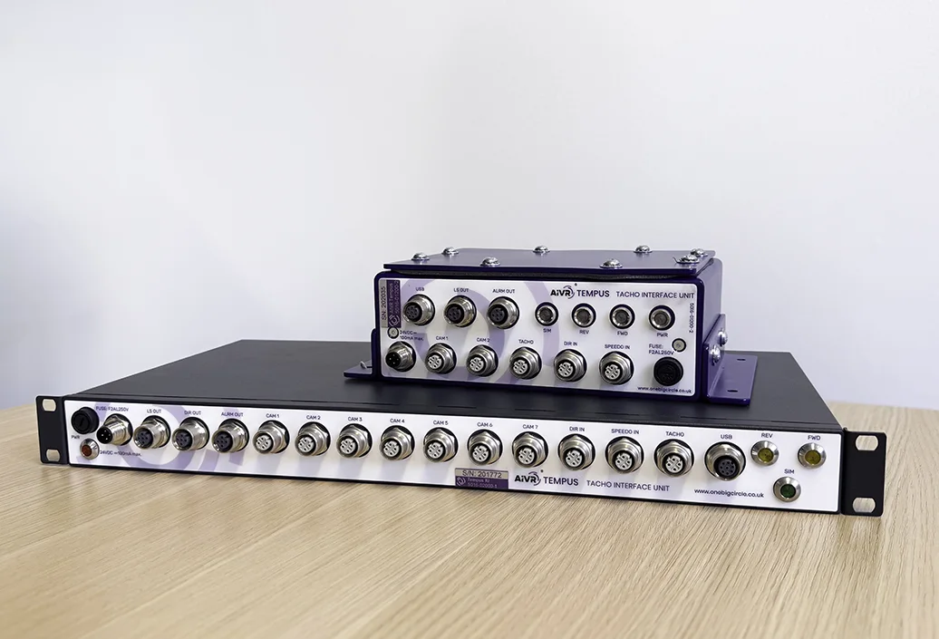 Two AIVR Tempus units on a table: a long rack-mounted unit at the front and a smaller unit on top of it, both with rows of connector ports.